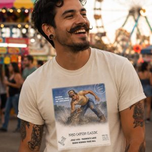 Man at county fair wearing shirt from Boondrift featuring a cat fish competition from the 80's. It is part of Boondrfit's Boondrift Sports collection. Man is laughing with friends.