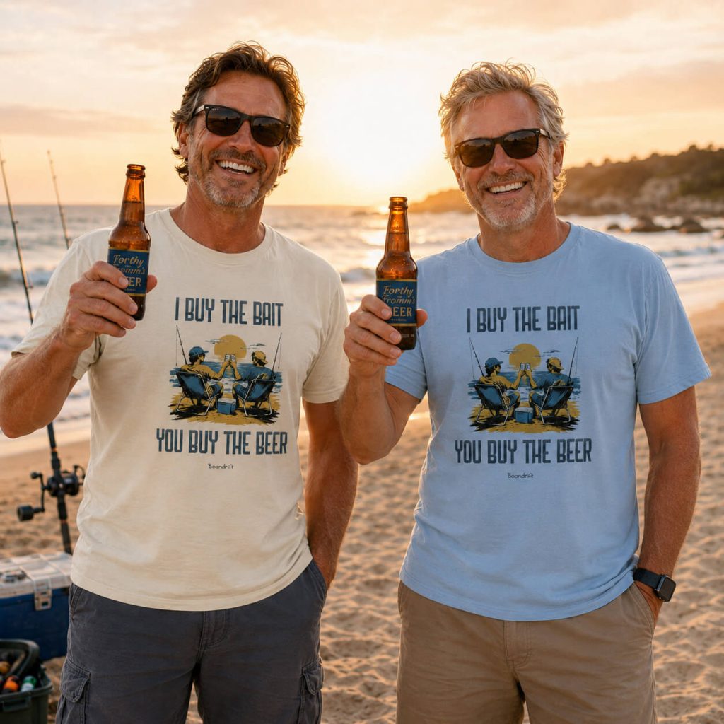 Two guys enjoying beers wearing shirts from Boondrift that read "I Buy the Bait, You Buy the Beer." They are at the beach.