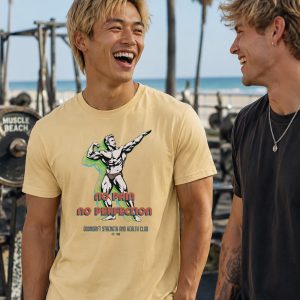 Handsome Asian man wearing "No Pain, No Perfection" t-shirt from Boondrift on a Soft Cream T-shirt. He is laughing with his friend at a beachside gym.